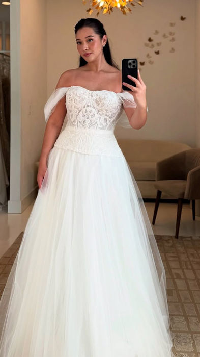 Bride to be wearing 2 piece vintage wedding dress, with lace corset, swag sleeves and lace up back!