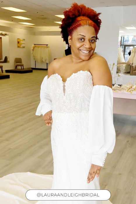 Woman wearing stunning Fit-n-Flare gown with heavily beaded lace and sequins and sleeves