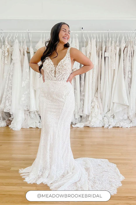 Woman wearing divine all over ivory lace and sequins wedding dress