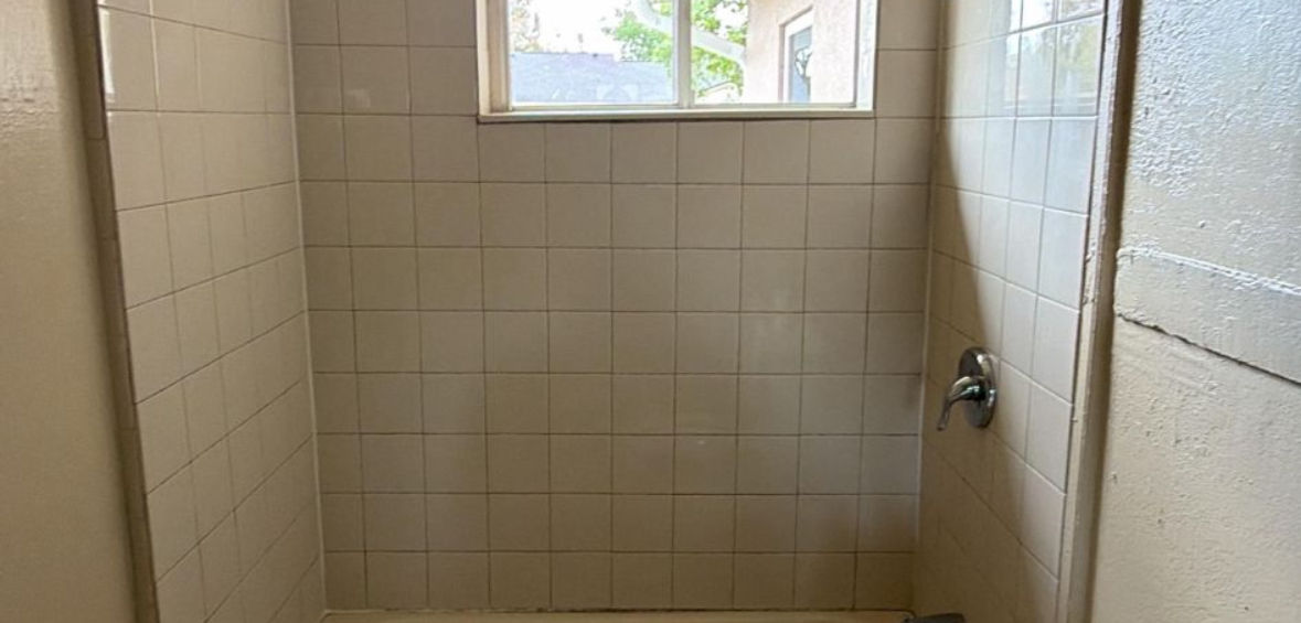 Perfectly restored white tile grout during professional shower restoration service in Florida.