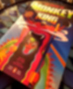 Cover of Monkey King: Journey to the West on a blue stained glass table.