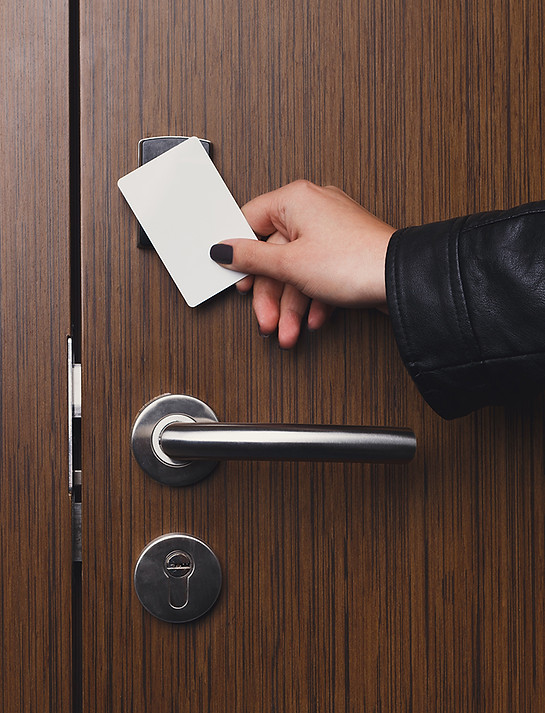 hand-inserting-key-card-in-electronic-lo