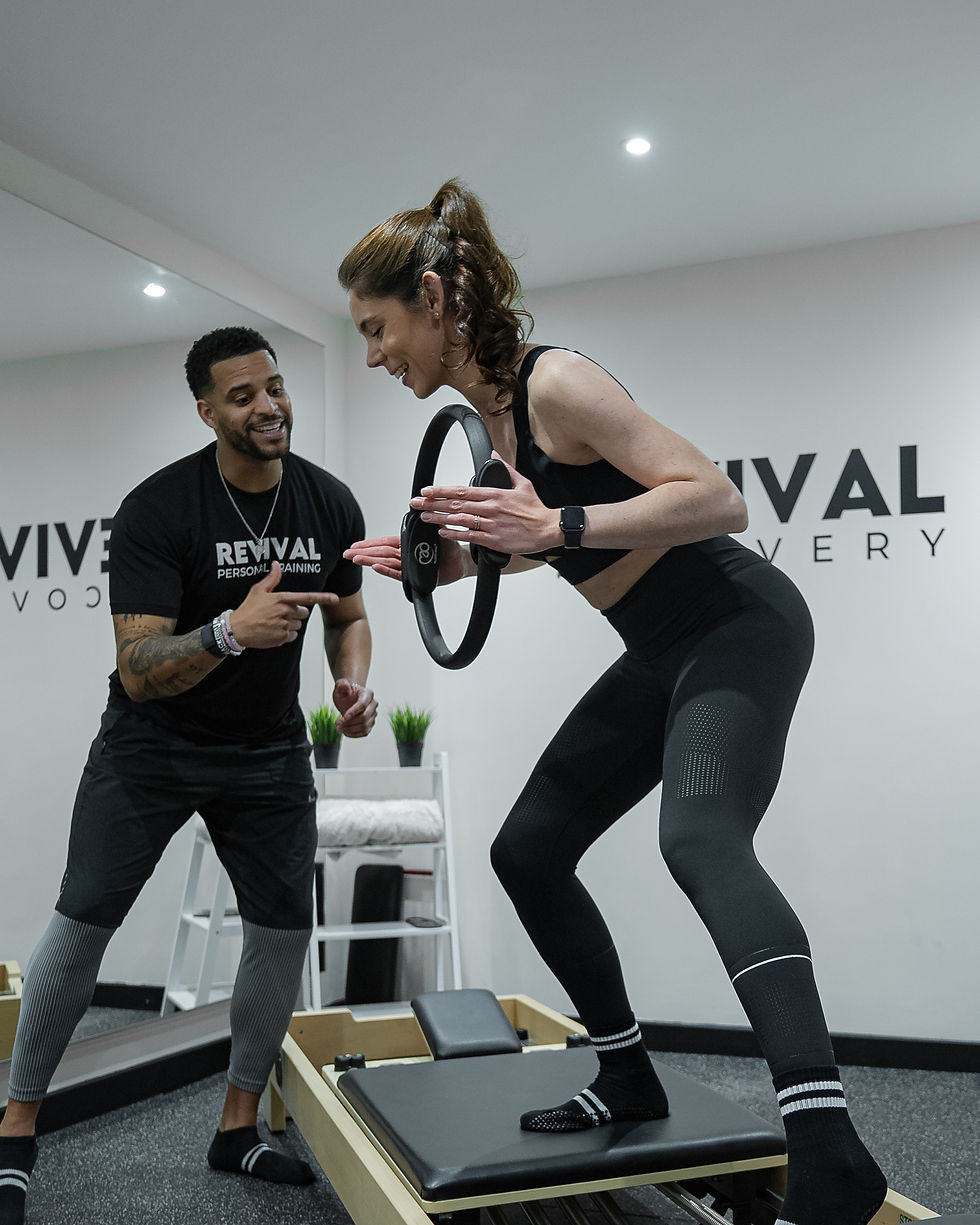Reformer Pilates instructors & Personal Trainers Joao Pina & Natacha Pinto on the reformer at REVIVAL Recovery in West London.