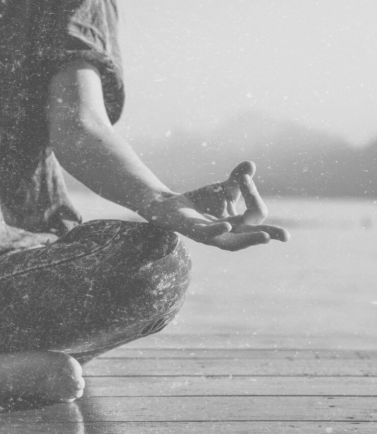 Person sitting crossed legged meditating