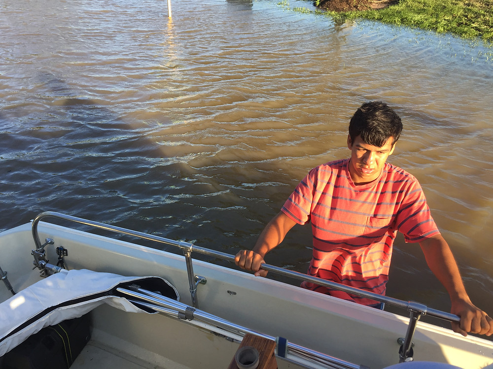 Ben helps steady the boat in the street