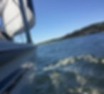 sailboat on crystal clear sunny water