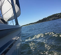 sailboat on crystal clear sunny water