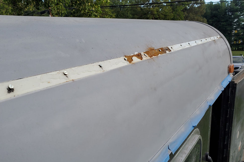 Zoomed out photo of rusted roof after rail was removed