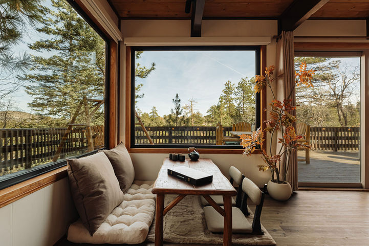 wabi-sabi living room nook with sweeping views of the big bear forest from the picture windows