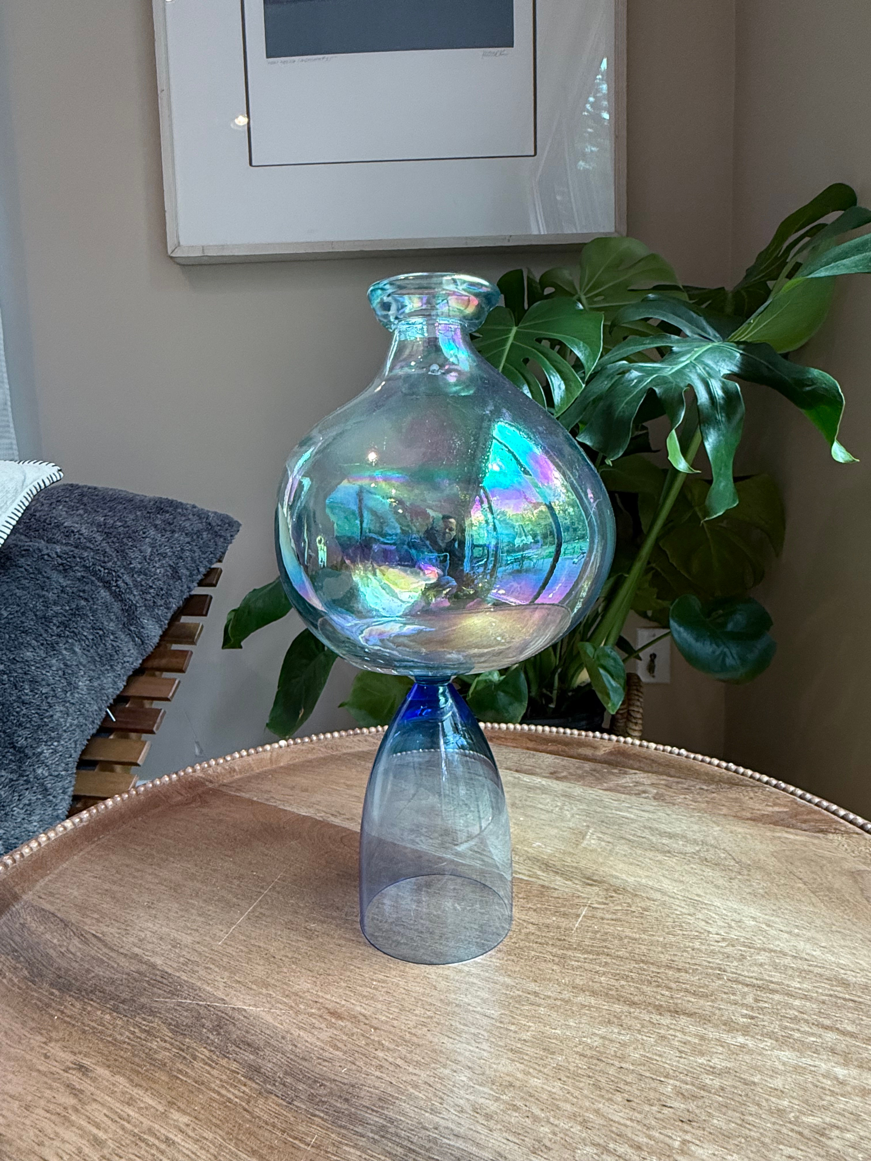 Iridescent hand-blown glass vase with round bulb body and blue glass base