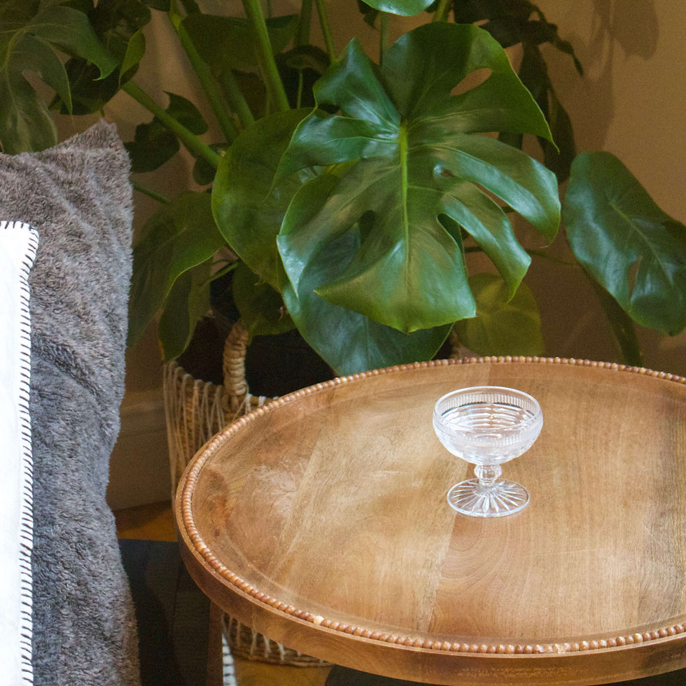 Thumbnail: Ribbed vintage pressed glass coupe on wooden table with tropical plant backdrop