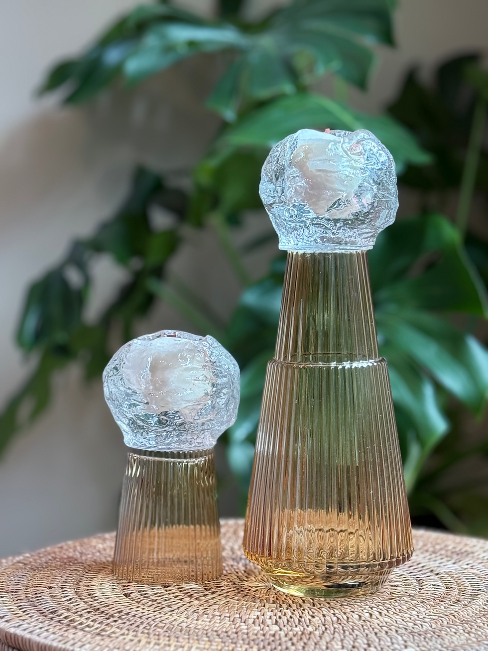 Golden hour sculptural candles in amber ribbed glass vases