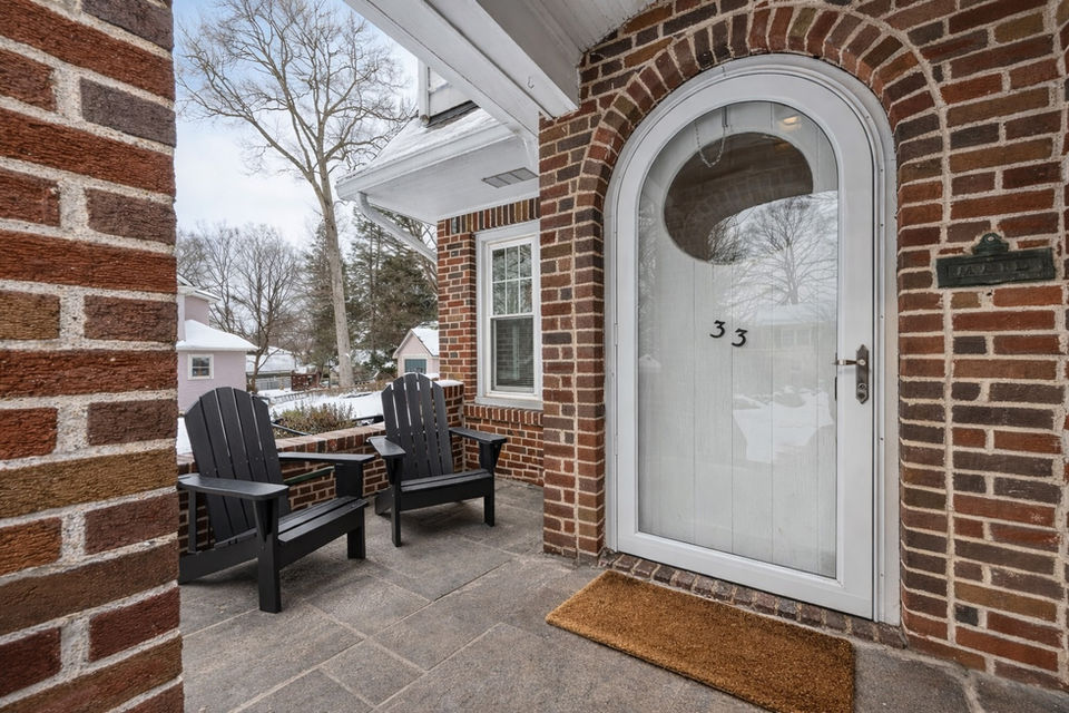 Charming arched front entry of a brick Colonial home at 33 Homewood Avenue, Allendale, New Jersey, highlighting timeless design and welcoming character.