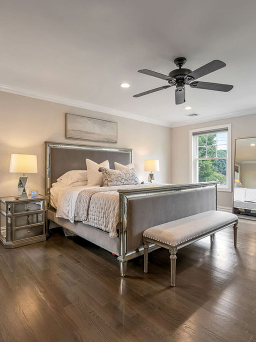 Primary bedroom suite with hardwood flooring, abundant natural light, and spacious layout in a Bergen County home for sale.