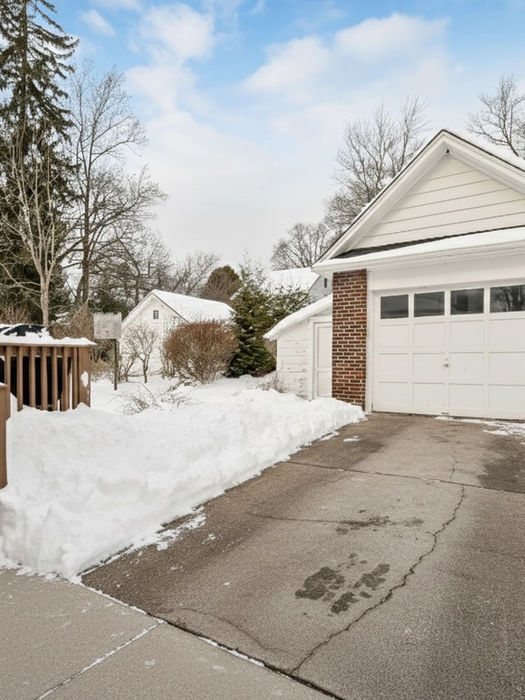 Rear exterior of 33 Homewood Avenue in Allendale, New Jersey, featuring detached garage and private outdoor space in Bergen County.