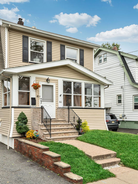 Colonial with a covered porch and landscaped lawn at 60 Mohr Avenue, Bloomfield, NJ