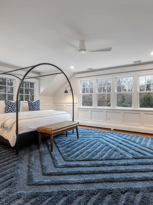 Primary bedroom at 241 Grove St Ramsey NJ with vaulted ceilings large windows and spacious layout luxury home