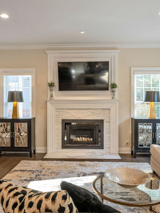 living room with gas fireplace and large windows at 26 Barrister Court Fair Lawn NJ luxury townhome Bergen County