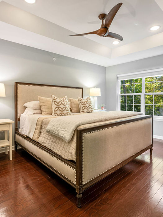 Primary bedroom with a tray ceiling, ceiling fan and hardwood floors at 16 Pineview Drive, Waldwick, NJ