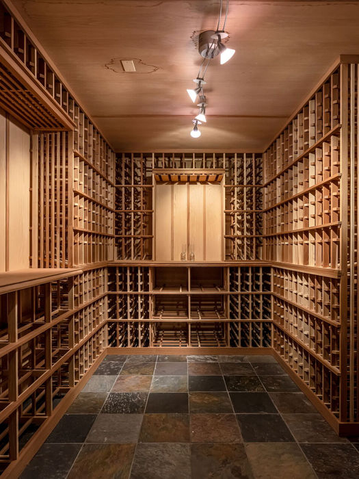 Temperature-controlled wine cellar with custom wood storage racks in luxury Allendale home.