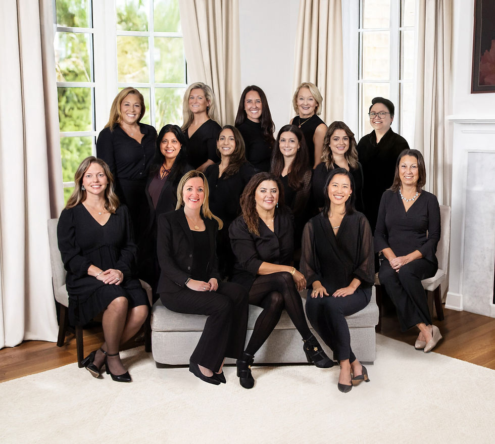 The Gill Group real estate team — fourteen women in black attire — posing together in a bright, elegant Ridgewood, NJ setting, showcasing unity, professionalism, and Bergen County market expertise.