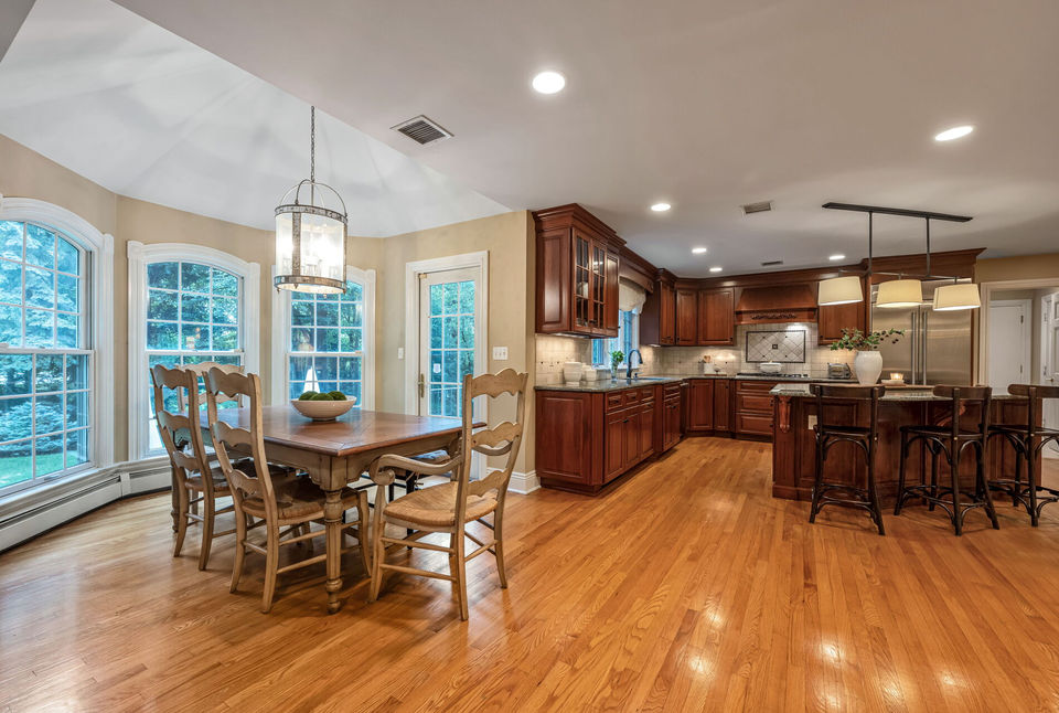 Open kitchen and breakfast area with hardwood flooring in luxury home for sale in Allendale NJ.