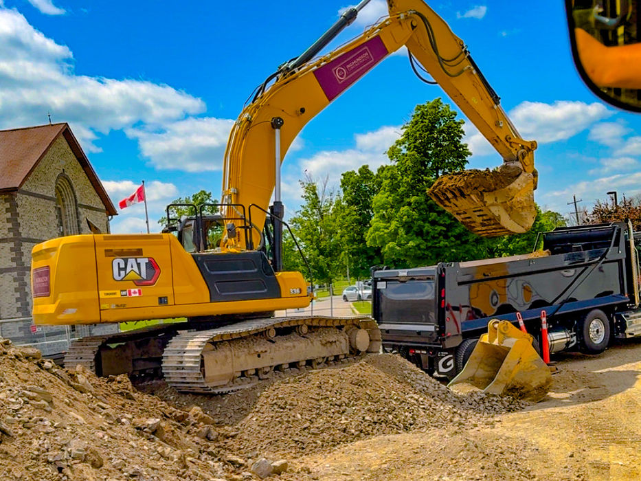 Yellow excavator digging dirt