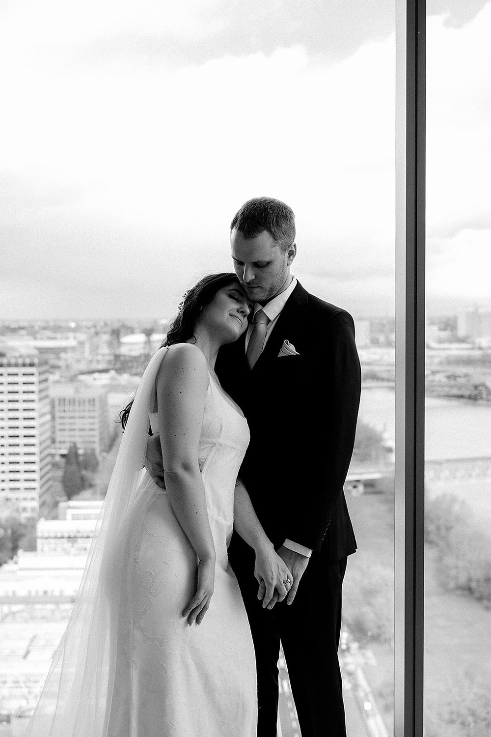 Bride and groom hug during courthouse wedding at Multnomah County Courthouse in Portland, Oregon.