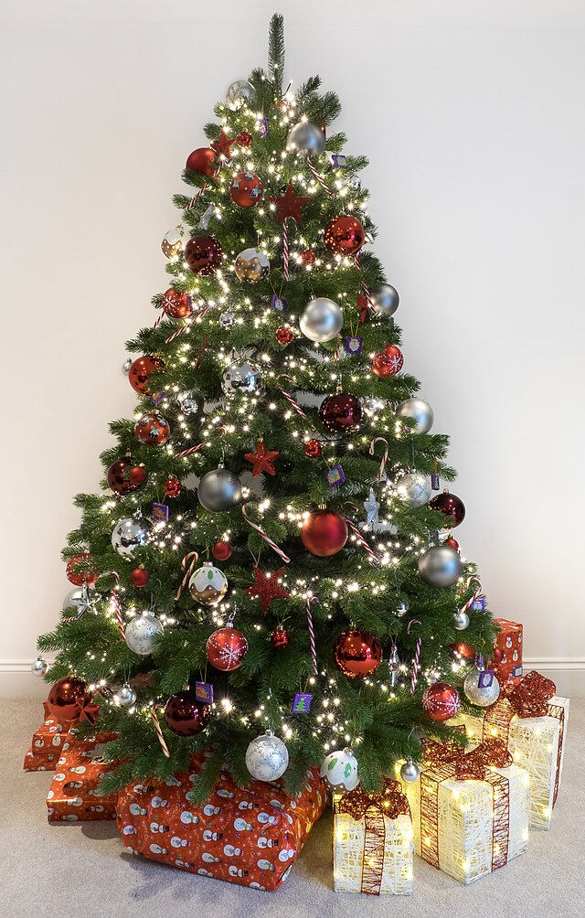 Christmas tree with lights and balls, presents underneath