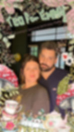 Tea for Emma, couple, smiling, floral tea set, and decorative elements in the background