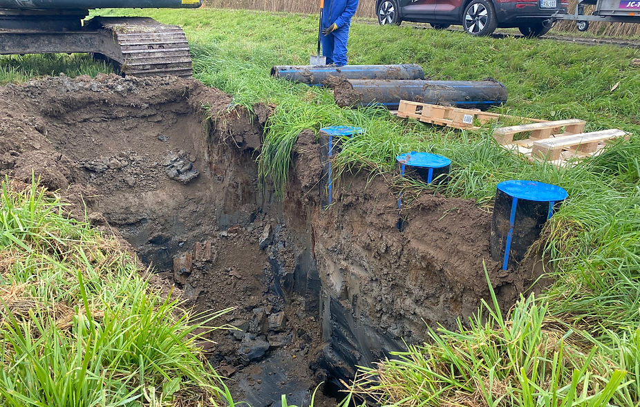 A trench dug in an agricultural field by an excavator.