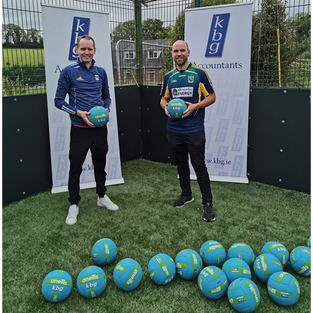 Cormac Smith (KBG) presenting 20 new footballs to Gerry Reilly of Ballyhaise U-7