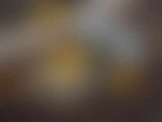 Journal, laptop, and coffee cup surrounded by autumn leaves