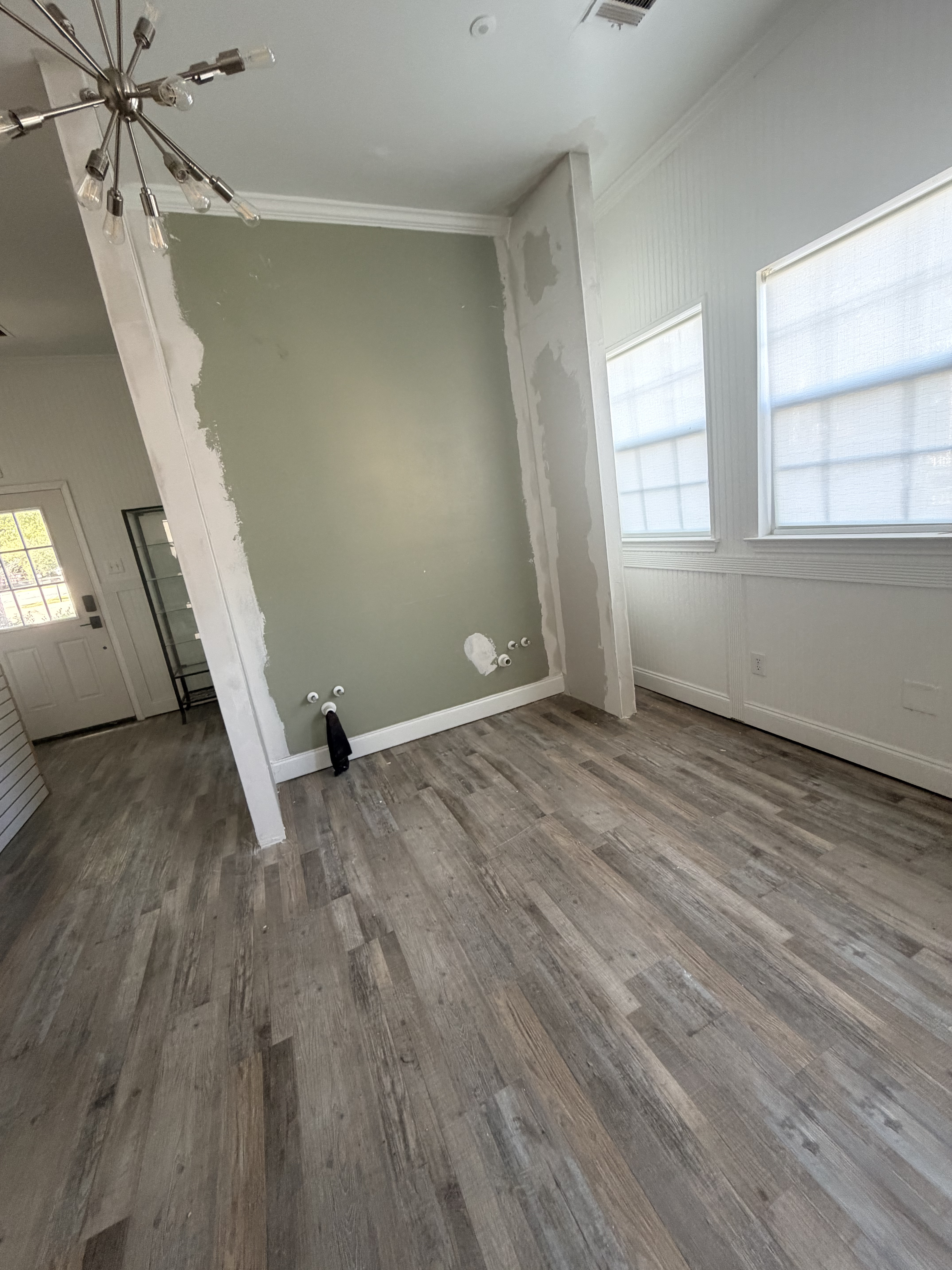 Flooring and sage green accent wall going in