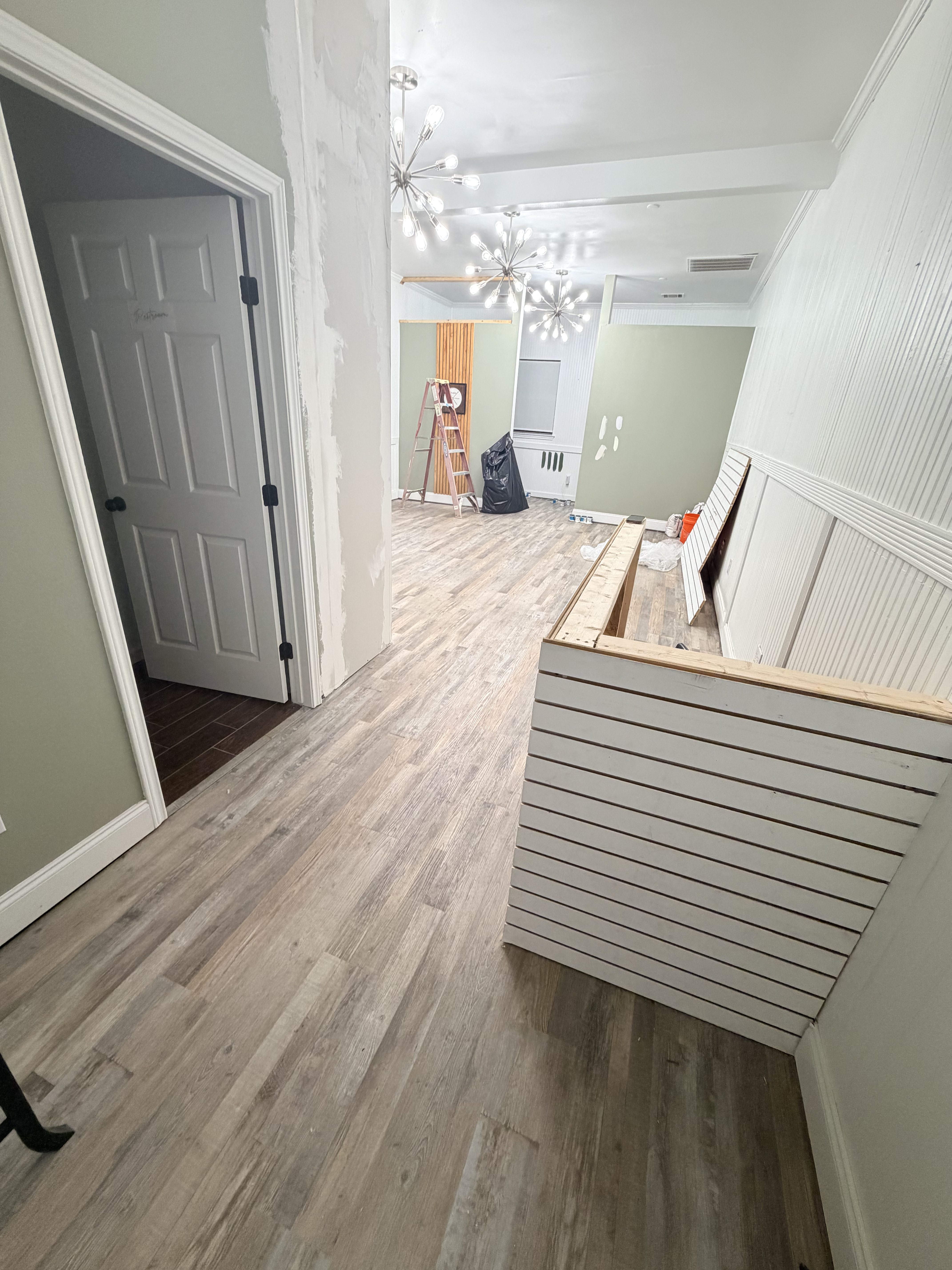 The wood slat wall going up