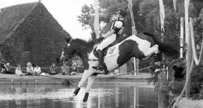 Eventing horse & rider jumping into a water jump cross country