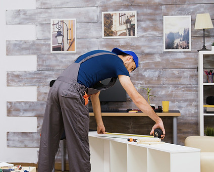 furniture-assembly-worker-standing-reading-instruction-using-tape-measure-worker-tools.jpg