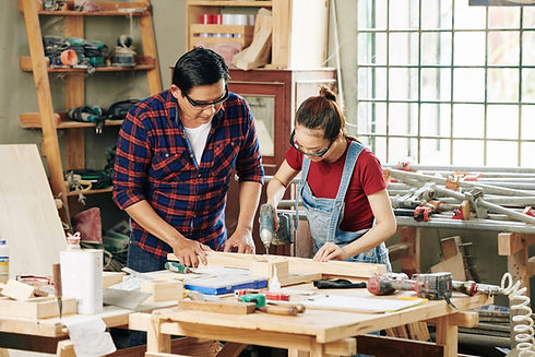 female-carpentry-worker-drilling-wooden-planks-control-woodworker.jpg