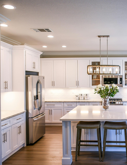 Custom white kitchen cabinets with island and stainless steel appliances Springfield MO