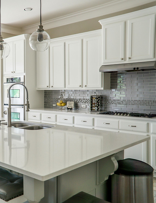 Quartz kitchen countertops with white cabinets and modern backsplash Springfield MO