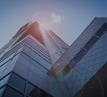 low-angle photography of blue glass wall