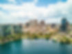 Aerial view of Orlando cityscape featuring buildings and a lake