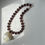 Thumbnail: THE SHELLS NECKLACE IN AUBERGINE