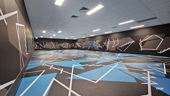 large room with carpet floor with abstract shape patterns on the carpet