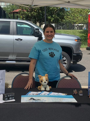 Marcy at a table for The Right Fluff pet sitting at the Leisure World Pet Preparedness Expo