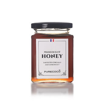Natural honey jar studio product image on reflective surface,