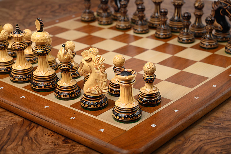 Wooden chess board with acacia wood pieces, styled product photography