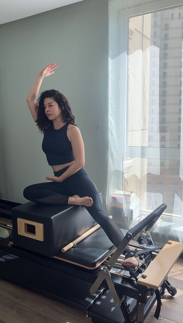 Woman doing Pilates on a reformer machine