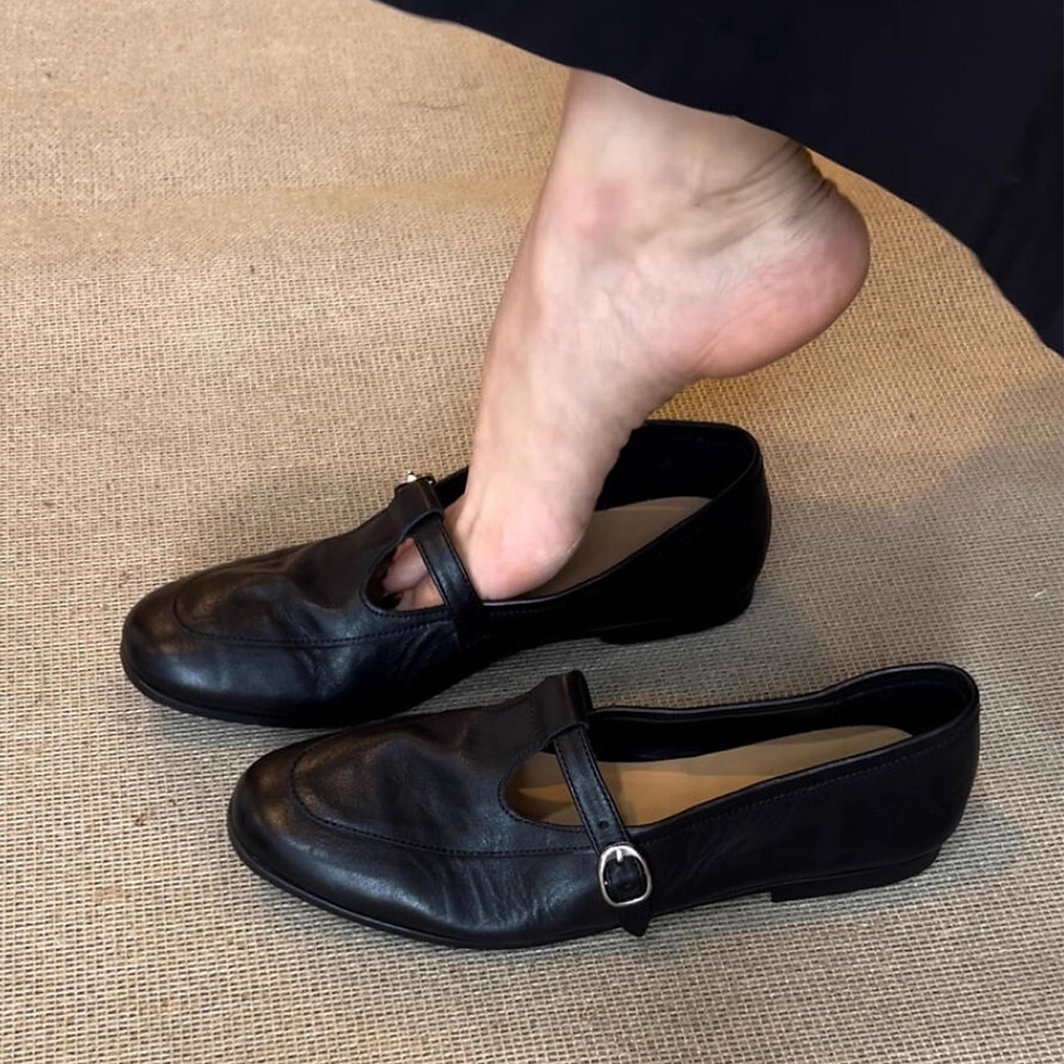 Thumbnail: Person trying on black vintage square toe Mary Jane flats