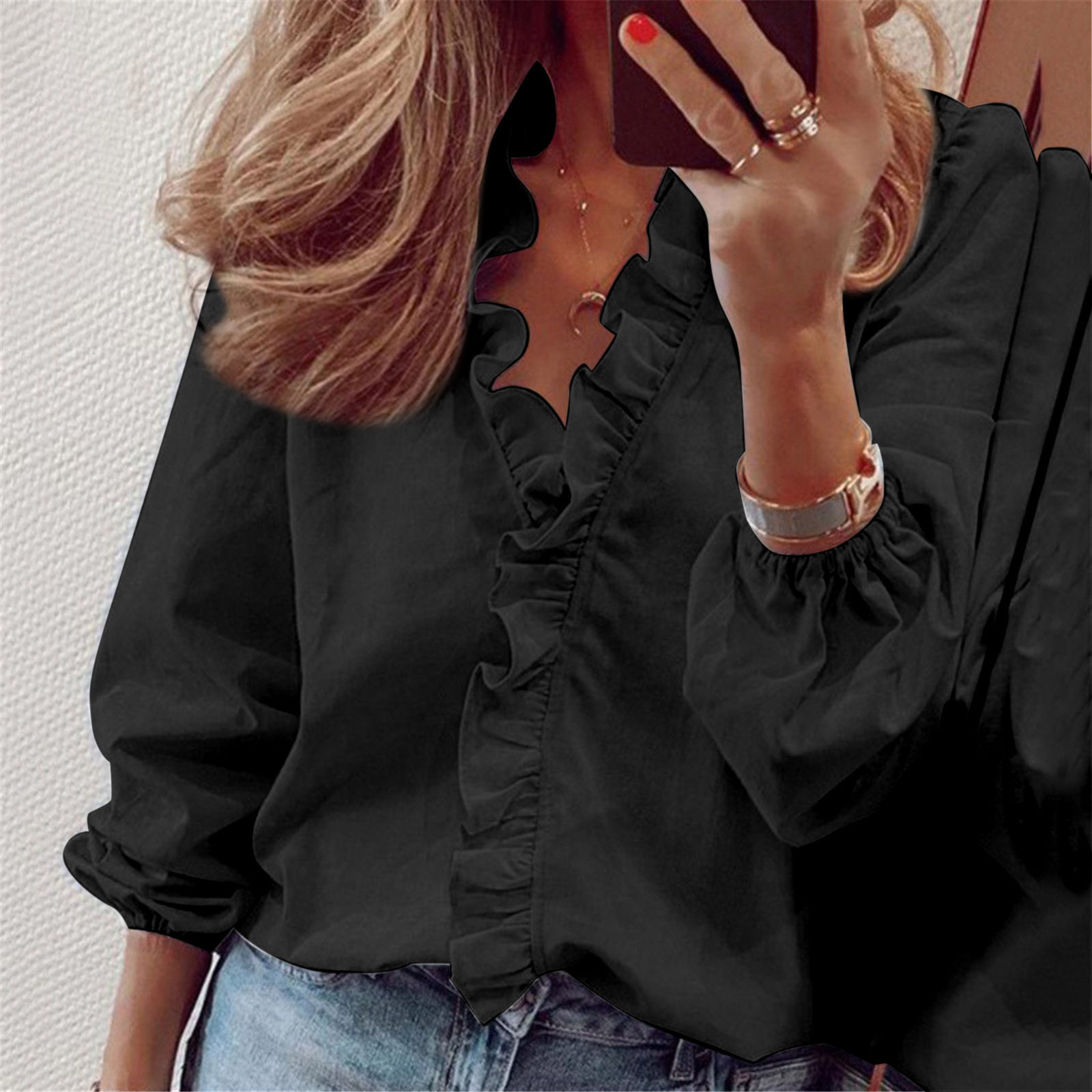Black vintage ruffle blouse with long sleeves and jeans.